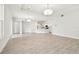 Spacious living room with wood-look tile flooring, open layout and a view of the kitchen at 2973 Breezy Meadows, Clearwater, FL 33760