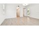 Living room featuring wood-look tile floors, white walls, and access to hallway and back patio at 2973 Breezy Meadows, Clearwater, FL 33760