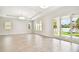 Bright living room with wood tile flooring, recessed lighting, and sliding doors leading to the backyard at 2973 Breezy Meadows, Clearwater, FL 33760