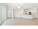 Open-concept space with a view to the kitchen, and sliding glass doors at 2973 Breezy Meadows, Clearwater, FL 33760