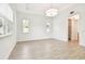Spacious living room boasts white walls, wood-look flooring and large windows allowing for natural light at 2973 Breezy Meadows, Clearwater, FL 33760