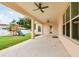 Covered patio with ceiling fans overlooking a fenced backyard with a wooden playset at 2973 Breezy Meadows, Clearwater, FL 33760
