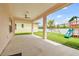 Spacious covered patio overlooking a backyard with a play set at 2973 Breezy Meadows, Clearwater, FL 33760