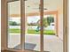 Covered patio view with a ceiling fan, concrete flooring, and a backyard with a playground set at 2973 Breezy Meadows, Clearwater, FL 33760