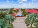 Inviting entrance to Pier 60, surrounded by palm trees and offering a gateway to beachfront enjoyment at 2973 Breezy Meadows, Clearwater, FL 33760