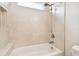 Close up view of shower over tub and neutral color tile surround with marble trim at 2973 Breezy Meadows, Clearwater, FL 33760