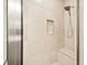 Close-up of tiled shower with built-in niche, bench and modern shower head at 2973 Breezy Meadows, Clearwater, FL 33760