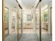 Mirrored closet doors reflecting a bathroom with double sinks and toilet at 307 Los Prados Dr # 307, Safety Harbor, FL 34695