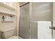Bathroom with toilet, shelves, and glass enclosed shower at 307 Los Prados Dr # 307, Safety Harbor, FL 34695