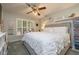 Charming bedroom with a large bed, shutters, and two shelves at 307 Los Prados Dr # 307, Safety Harbor, FL 34695