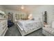 This bedroom has a queen bed, shelves, and a blue armchair at 307 Los Prados Dr # 307, Safety Harbor, FL 34695