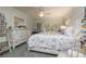 Bright bedroom features blue floral bedding, white furniture, and a ceiling fan at 307 Los Prados Dr # 307, Safety Harbor, FL 34695