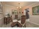 This dining room area features a glass table, woven chairs, and a chandelier light fixture at 307 Los Prados Dr # 307, Safety Harbor, FL 34695