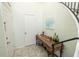 Bright entryway featuring a decorative table, art, and staircase access at 307 Los Prados Dr # 307, Safety Harbor, FL 34695