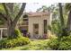 Inviting two-story home featuring a balcony, tile roof, and lush landscaping at 307 Los Prados Dr # 307, Safety Harbor, FL 34695