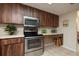 This kitchen has stainless steel appliances, wood cabinets, and ample counter space at 307 Los Prados Dr # 307, Safety Harbor, FL 34695