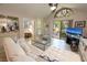Inviting living room featuring a modern glass table, white couches, and a large window at 307 Los Prados Dr # 307, Safety Harbor, FL 34695