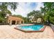 Community pool area with lounge chairs and clubhouse at 307 Los Prados Dr # 307, Safety Harbor, FL 34695