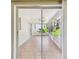Enclosed lanai with tile flooring and a view of the backyard and exterior greenery at 3249 Parkway Pl, Palm Harbor, FL 34684