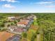 Beautiful aerial view of a residential neighborhood with tile roofs, screened-in pools and lush green lawns at 3326 Barbour Trl, Odessa, FL 33556
