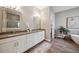 Elegant bathroom featuring double vanities, wood-look tile floors, and a separate tub and shower at 3326 Barbour Trl, Odessa, FL 33556