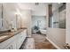 Bathroom with double sinks, soaking tub, and a separate glass-enclosed shower at 3326 Barbour Trl, Odessa, FL 33556