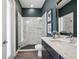 This bathroom features a glass shower, granite counters, and dark wood cabinets at 3326 Barbour Trl, Odessa, FL 33556