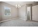 Bright bedroom with carpet, a chandelier, and a walk-in closet at 3326 Barbour Trl, Odessa, FL 33556