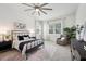 Bright bedroom featuring a ceiling fan, neutral decor, and comfortable chair by the windows at 3326 Barbour Trl, Odessa, FL 33556