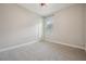 Bedroom featuring carpeted floors, a window with blinds, and neutral-colored walls at 3326 Barbour Trl, Odessa, FL 33556