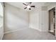A clean, bright bedroom with neutral carpet, a ceiling fan and a spacious closet at 3326 Barbour Trl, Odessa, FL 33556