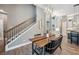 Dining area featuring a modern wood table and staircase, offering a view into the kitchen at 3326 Barbour Trl, Odessa, FL 33556