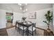 Cozy dining room featuring shiplap accent wall, contemporary light fixture and dark wood table at 3326 Barbour Trl, Odessa, FL 33556