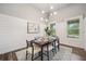 Bright dining room with a modern light fixture, shiplap walls, and backyard view at 3326 Barbour Trl, Odessa, FL 33556