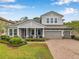 Beautiful two-story home with manicured lawn, brick-paved driveway, and three-car garage at 3326 Barbour Trl, Odessa, FL 33556