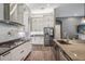 Modern kitchen featuring stainless steel appliances, light blue backsplash, and granite countertops at 3326 Barbour Trl, Odessa, FL 33556