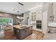 Bright, open kitchen with stainless steel appliances, granite countertops, and hardwood floors at 3326 Barbour Trl, Odessa, FL 33556