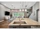 Spacious kitchen with large island, granite countertops, stainless steel appliances, and wood flooring at 3326 Barbour Trl, Odessa, FL 33556