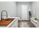 Well-lit laundry room with sink, washer/dryer hookups, counter space, and storage at 3326 Barbour Trl, Odessa, FL 33556