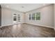 This living room has wood-look tile and glass doors leading to the patio at 3326 Barbour Trl, Odessa, FL 33556