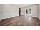 Spacious living room with wood-look tile and sliding glass doors leading to the patio at 3326 Barbour Trl, Odessa, FL 33556