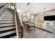 Open-concept living area with modern lighting, stairs, dining table and wood-look floors at 3326 Barbour Trl, Odessa, FL 33556