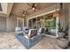 Covered patio features ceiling fans, stylish seating, and a seamless transition to indoor living through sliding glass doors at 3326 Barbour Trl, Odessa, FL 33556