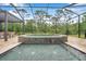 Sparkling pool and spa in a screened-in lanai with an outdoor dining area at 3326 Barbour Trl, Odessa, FL 33556