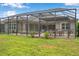 This screened-in patio provides a comfortable outdoor living space with a dining area and access to the backyard at 3326 Barbour Trl, Odessa, FL 33556