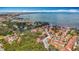 Beautiful aerial view of a coastal community with vibrant homes, lush trees, and calm waters with boats dotting the bay at 3620 41St S Way # B, St Petersburg, FL 33711