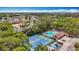 Aerial view featuring community pool, tennis court, recreational area, and tropical landscaping at 3620 41St S Way # B, St Petersburg, FL 33711