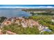 A high aerial view of waterfront homes, showing lush greenery and boat-dotted waters with a cityscape backdrop at 3620 41St S Way # B, St Petersburg, FL 33711