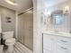 Well-lit bathroom with classic black and white tile flooring, vanity, and glass shower at 3620 41St S Way # B, St Petersburg, FL 33711