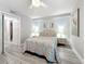 Bright bedroom with hard surface floors, side tables, and comfortable, stylish decor at 3620 41St S Way # B, St Petersburg, FL 33711